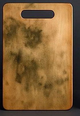 Wooden cutting board stained and darkened from use